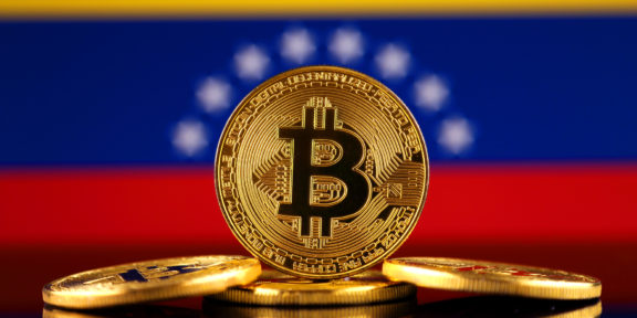 Physical version of Bitcoin (new virtual money) and Venezuela Flag.