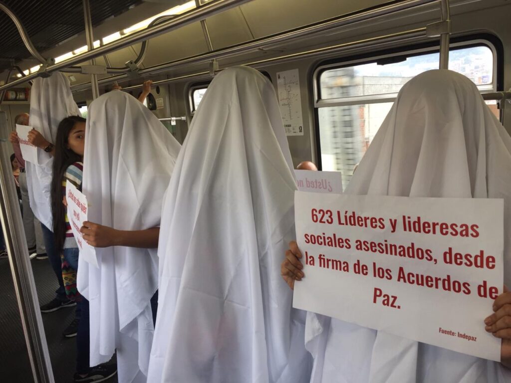 Demonstrators in white sheets are protesting the killings of social leaders in Colombia
