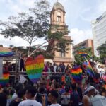 Medellin Pride parade float crowd flag