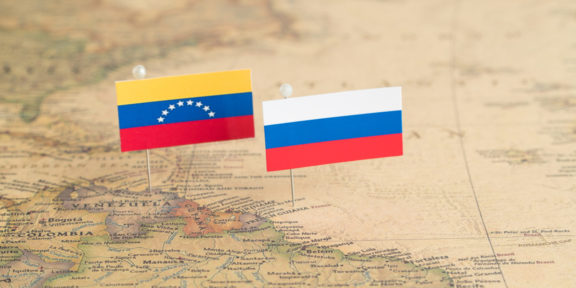 Venezuela and Russian flags on a map